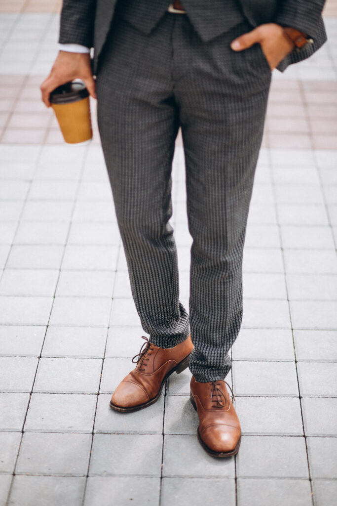 male suit close up holding coffee in hand